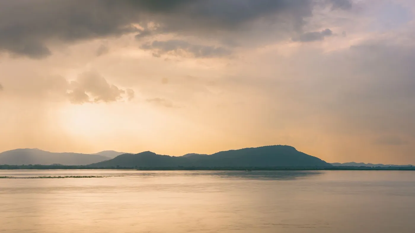 sunset over the Brahmaputra in Assam, hills along the far bank